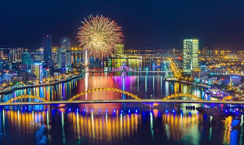 Aerial night view of Da Nang skyline with fireworks above the Han River and illuminated bridges